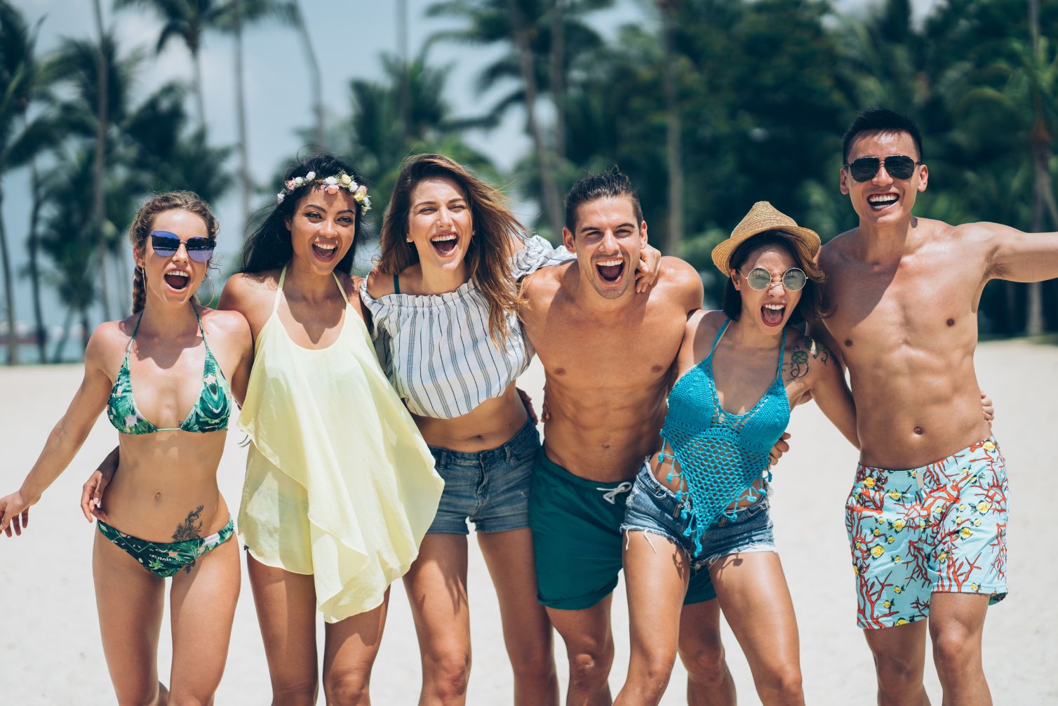 A group of smiling people at the beach