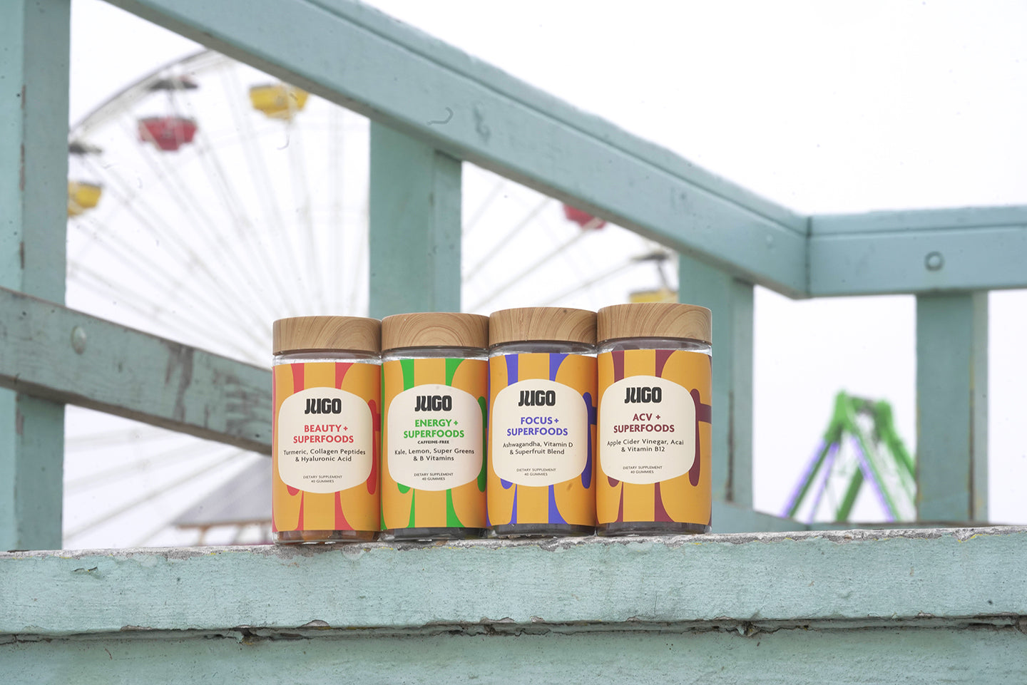Zoomed out JUGO Superfood gummies next to a ferris wheel