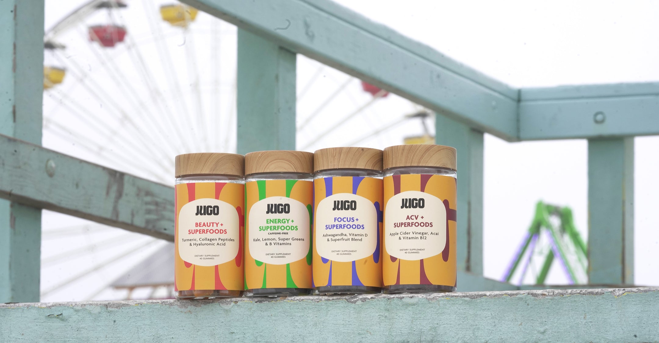 Zoomed in JUGO Superfood gummies next to a ferris wheel