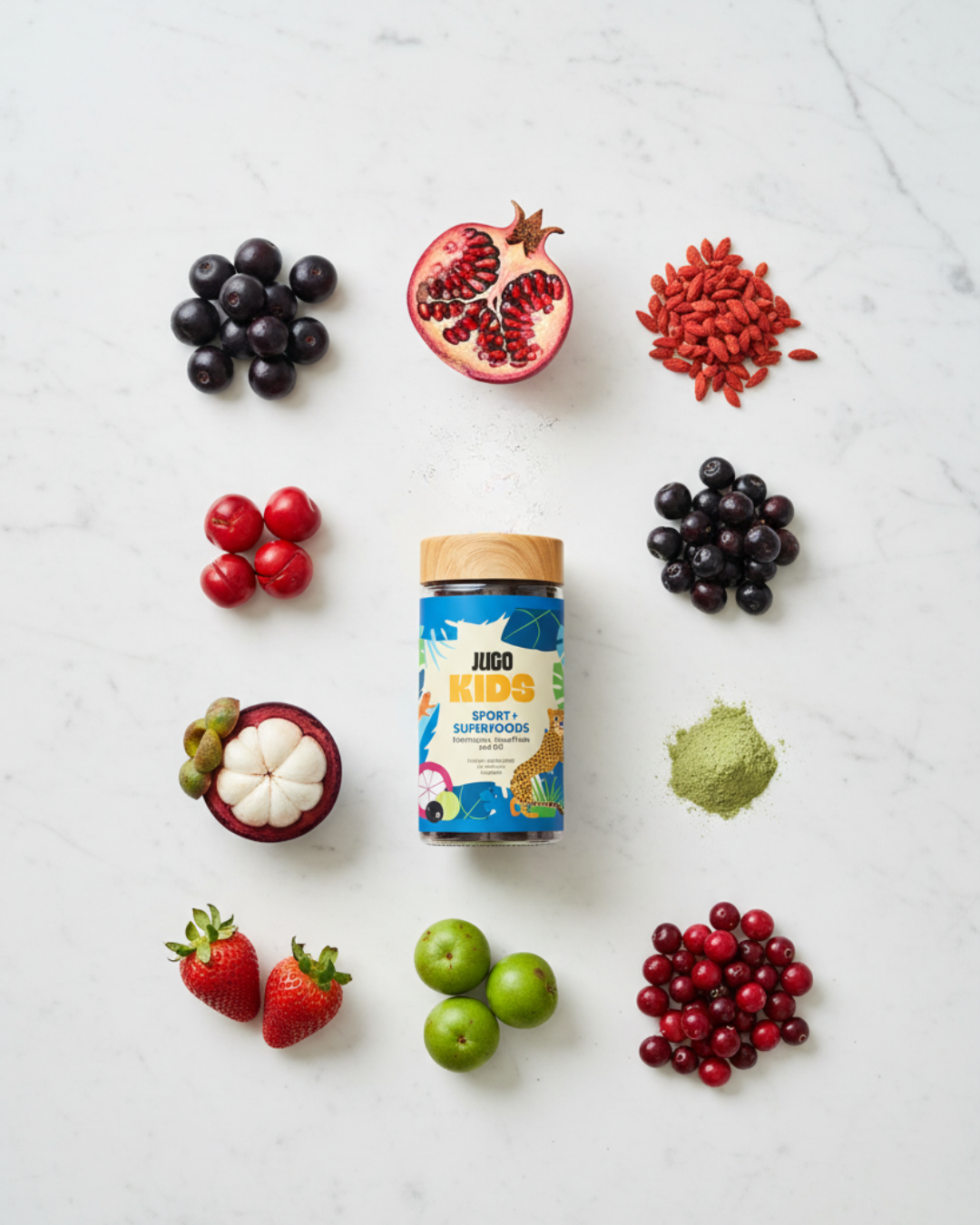 Flat-lay of a Jugo Kids Sport Superfoods bottle surrounded by colorful fruits and berries on a white background.