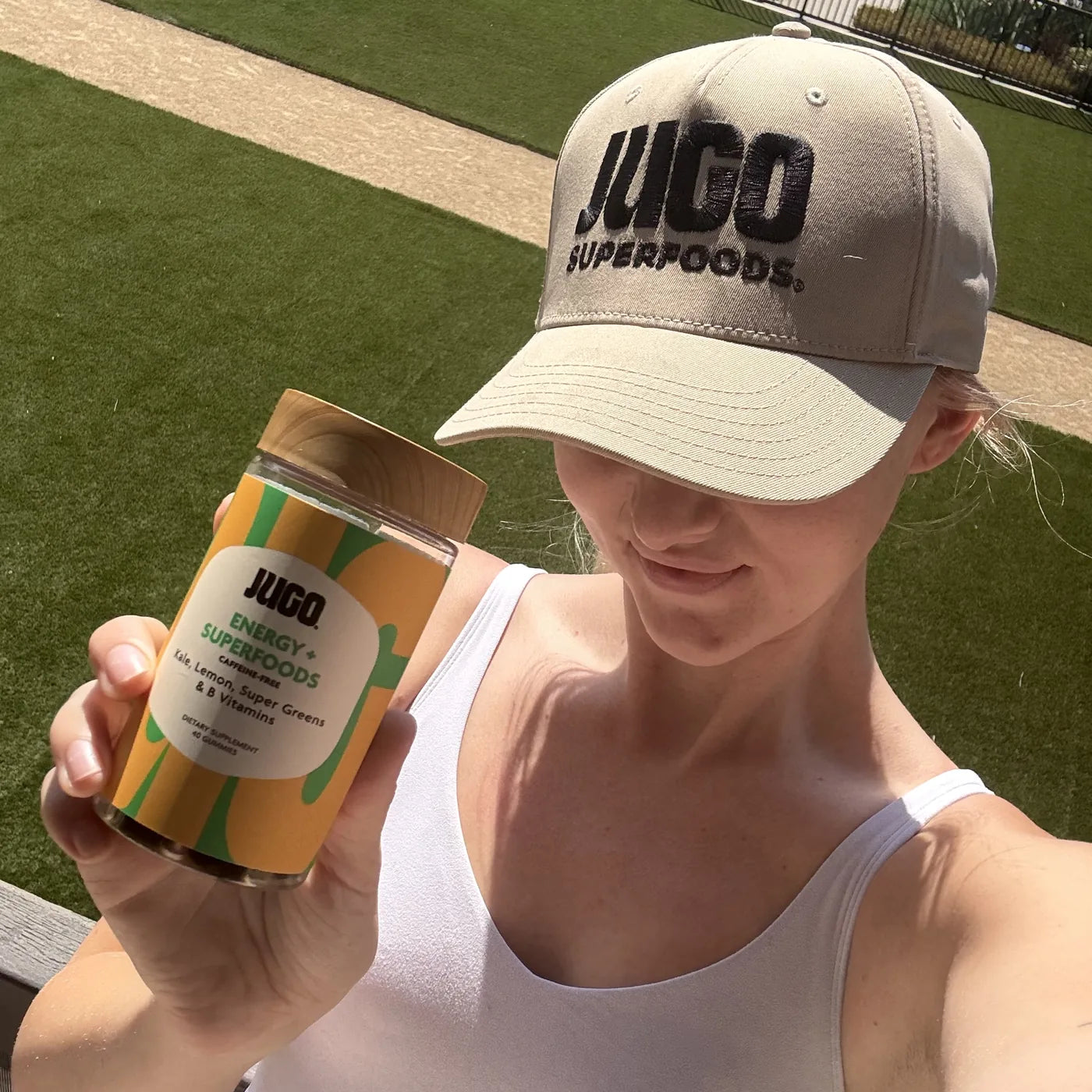 A JUGO Energy + Superfoods fan holding the jar after a workout