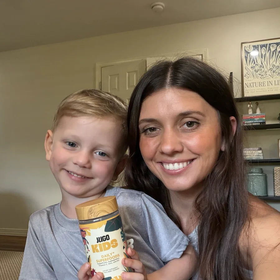 A parent and child sharing JUGO Kids gummies