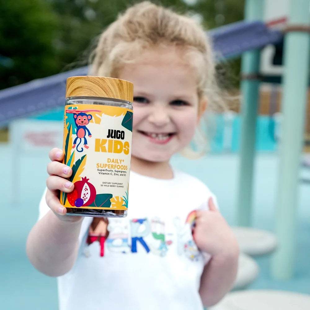 A child enjoying their daily JUGO Kids gummies