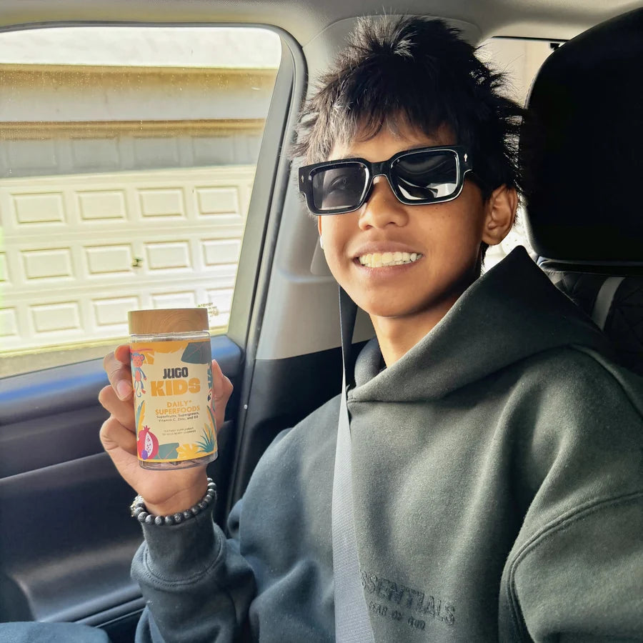 Child with their JUGO Kids gummies