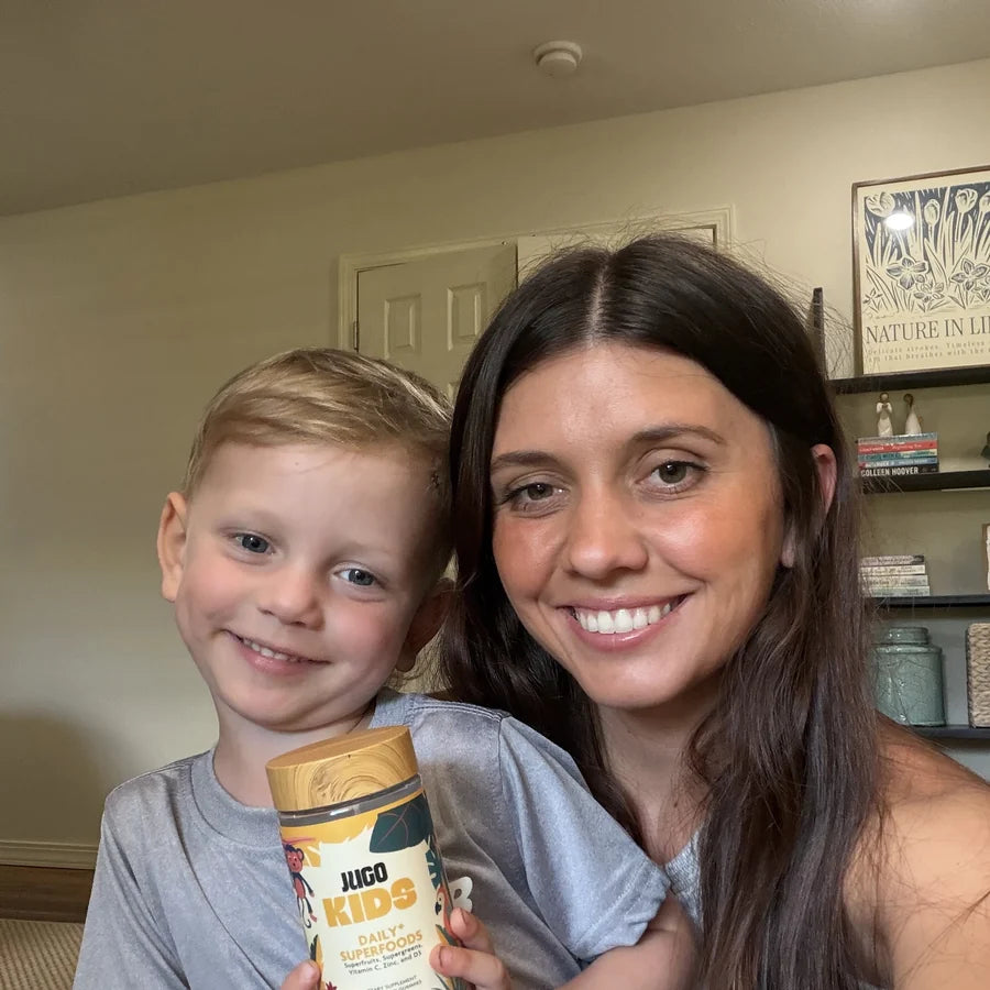 A parent and child sharing JUGO Kids gummies